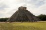 A group of people standing in front of a pyramid